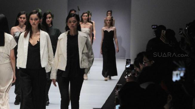 Sejumlah model saat menampilkan karya kolaborasi Fashionlinkx #BLCKVNUE pada JFW 2019 di Senayan, Jakarta Pusat, Jum'at (26/10).(Suara.com/Fakhri Hermansyah) 