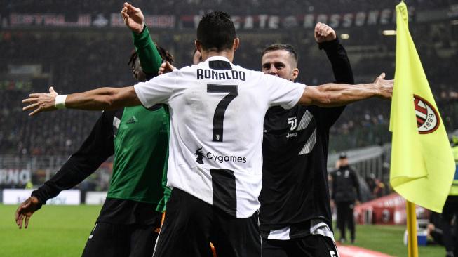 Cristiano Ronaldo merayakan golnya dengan gelandang Miralem Pjanic setelah mencetak gol ke gawang Ac Milan selama pertandingan sepak bola Serie A Italia AC Milan melawan Juventus di Stadion San Siro, Milan, Italia, Senin (12/11). [AFP/Marco BERTORELLO]