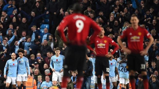 Para pemain Manchester City merayakan gol Ilkay Gundogan ke gawang Manchester United di Etihad Stadium. Oli SCARFF / AFP