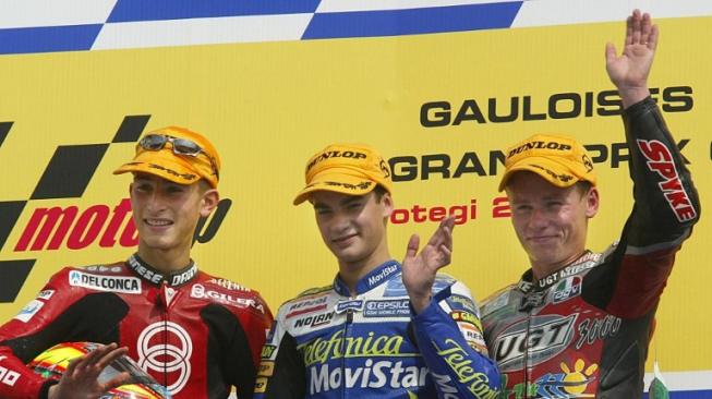 Dani Pedrosa (tengah) saat menjuarai balapan GP Pacific kelas 125cc di Sirkuit Motegi, Jepang, 6 Oktober 2002. Diikuti kemudian oleh Manuel Poggiali (kiri) dan Steve Jenkner. [AFP/Toshifumi Kitamura]