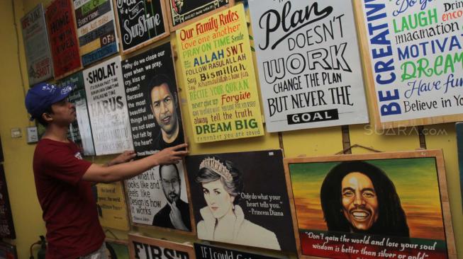 Pengrajin merapikan kerajinan Hand Wood bergaya retro di Pondok Bambu, Jakarta Timur, Sabtu (8/12). [Suara.com/Fakhri Hermansyah]