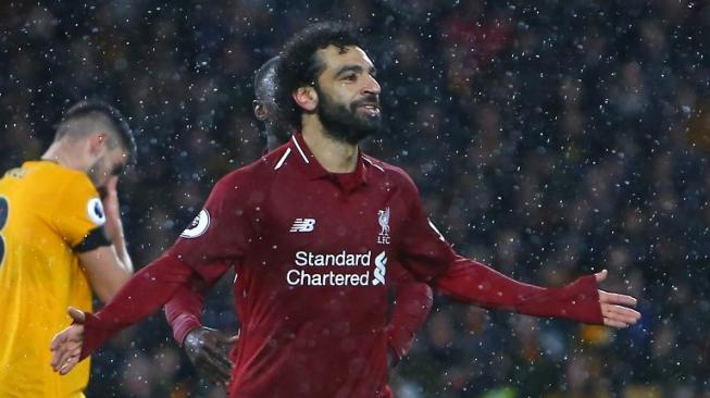 Selebrasi Mohamed Salah merayakan gol ke gawang Wolverhampton dengan kemenangan 0-2 untuk Liverpool. (Geoff CADDICK / AFP)
