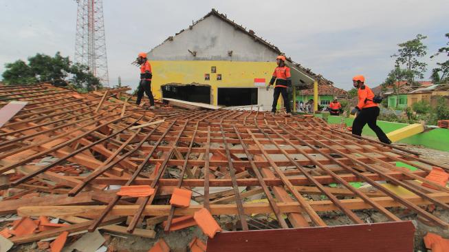 Sejumlah personel tim SAR membersihkan puing bangunan MTS Istiqomah yang roboh akibat angin puting beliung di Desa Panguragan Kulon, Kabupaten Cirebon, Jawa Barat, Senin (31/12). [ANTARA FOTO/Dedhez Anggara]