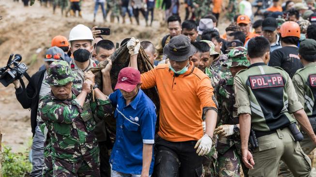 Petugas gabungan membawa korban longsor di kampung Cimapag, Desa Sirnaresmi, Kecamatan Cisolok, Kabupaten Sukabumi, Jawa Barat, Rabu (2/1). [ANTARA FOTO/M Agung Rajasa]