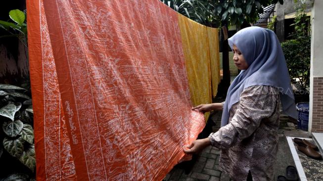 Sejumlah pengrajin menyelesaikan pembuatan kain batik khas Betawi di sentra industri rumahan di Cilandak, Jakarta Selatan, Sabtu (5/1). [Suara.com/Fakhri Hermansyah]