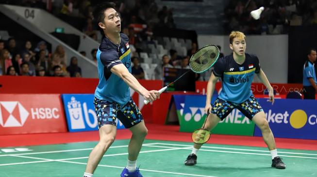 Ganda putra Indonesia Kevin Sanjaya Sukamuljo dan Marcus Fernaldi Gideon berusaha mengembalikan kok searah ganda Jerman Mark Lamfus dan Marvin Emil Seidel saat pertandingan babak pertama Daihatsu Indonesia Masters 2019 di Istora Senayan, Jakarta, Rabu (23/1). [Suara.com/Muhaimin A Untung]