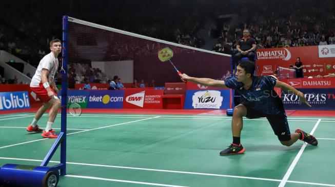 Pebulutangkis tunggal putra Indonesia Jonatan Christie berusaha mengembalikan kok ke arah pebulutangkis tunggal putra Denmark Rasmus Gemke dalam babak pertama Indonesia Masters 2019 di Istora Senayan, Jakarta, Rabu (23/1). [Suara.com/Muhaimin A Untung] 