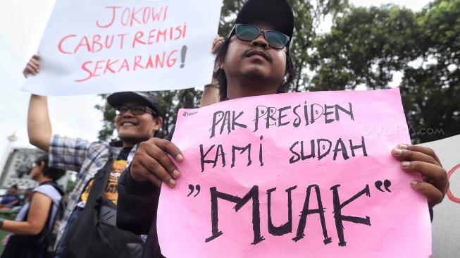 Sejumlah jurnalis membentangkan spanduk dan poster saat menggelar aksi tolak remisi pembunuh jurnalis di Taman Aspirasi, Jakarta, Jumat (25/1). [Suara.com/Muhaimin A Untung]