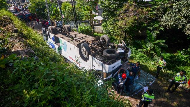 Petugas kepolisian melakukan olah tempat kejadian perkara kecelakaan bus Kramat Djati di Cikopo, Cicalengka, Kabupaten Bandung, Jawa Barat, Rabu (6/2). [ANTARA FOTO/Raisan Al Farisi]