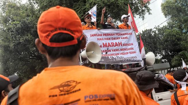 Karyawan PT POS Indonesia melakukakn aksi di depan Kantor Kementerian BUMN, Jakarta, Rabu (6/2). [Suara.com/Muhaimin A Untung]
