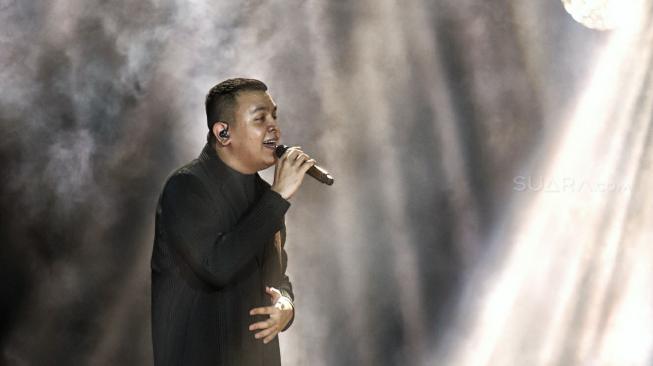 Penyanyi Tulus saat bernyanyi menghibur di Konser Monokrom Tulus di Istora Senayan, Jakarta, (6/2). [Suara.com/Muhaimin A Untung]