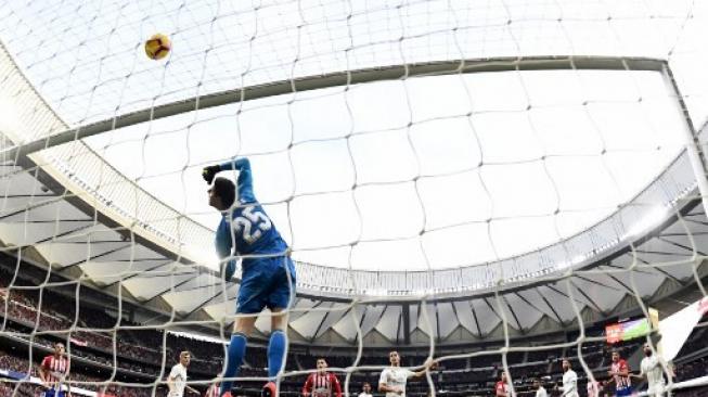 Aksi Thibaut Courtois kala melawan Atletico Madrid di Wanda Metropolitano, Sabtu (9/2/2019). (GABRIEL BOUYS / AFP)