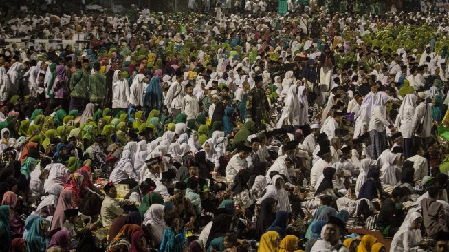 Puluhan ribu orang dari berbagai daerah hadir mengikuti acara Haul Gus Dur atau KH Abdurrahman Wahid yang ke-9 di Stadion Sriwedari Solo, Jawa Tengah, Sabtu malam (23/2/2019). [Antara//Mohammad Ayudha]