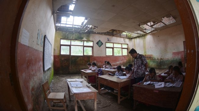 Siswa SDN Mulyorejo 05 belajar di ruang kelas yang rusak di Desa Mulyorejo, Silo, Jember, Jawa Timur, Rabu (27/2).  terakhir ini dan belum pernah ada perbaikan dari Pemerintah Kabupaten Jember. [ANTARA FOTO/Seno]