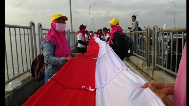 Pembentangan bendera Merah Putih terpanjang yang berhasil memecahkan rekor MURI  [Suara.com/Achmad Ali].. 