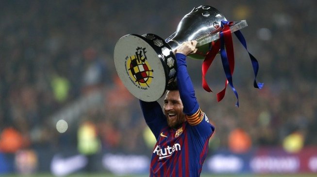 Striker Lionel Messi mengangkat trofi juara Liga Spanyol 2018/2019. (AFP)