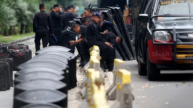 Aparat Kepolisian dilengkapi kendaraan taktis berjaga di kawasan Monas, Jakarta, Rabu (1/5). [Suara.com/Arief Hermawan p]