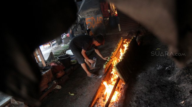 Pekerja menyelesaikan pembuatan Lemang di kawasan Pasar Senen, Jakarta, Jumat (17/5). [Suara.com/Arief Hermawan P]