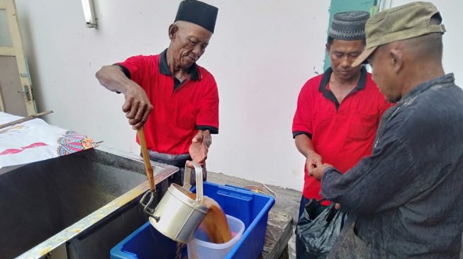 Warga menerima kolak ayam yang diberikan takmir Masjid Jami Sunan Dalem. [Suara.com/Tofan Kumara]