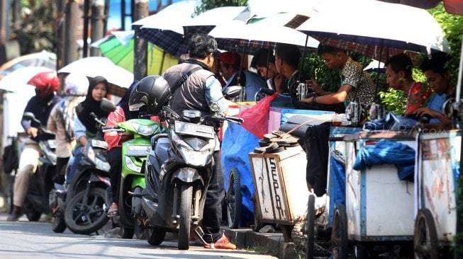 Sejumlah penjahit pakaian melayani pelanggan di kawasan Pasar Lenteng Agung, Jakarta Selatan, Jumat (31/5). [Suara.com/Arief Hermawan P]