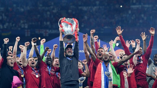 Para pemain Liverpool mengangkat trofi Si Kuping Besar dan merayakan kemenangan setelah pertandingan final Liga Champions antara Liverpool melawan Tottenham Hotspur di Stadion Wanda Metropolitano, Madrid, Spanyol, Minggu (2/5) dini hari WIB. [Paul ELLIS / AFP]