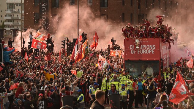 Para pemain Liverpool disambut ribuan penggemarnya saat parade juara Liga Champions dengan Bus terbuka di Liverpool, Inggris, Minggu (2/6). [Oli SCARFF / AFP]