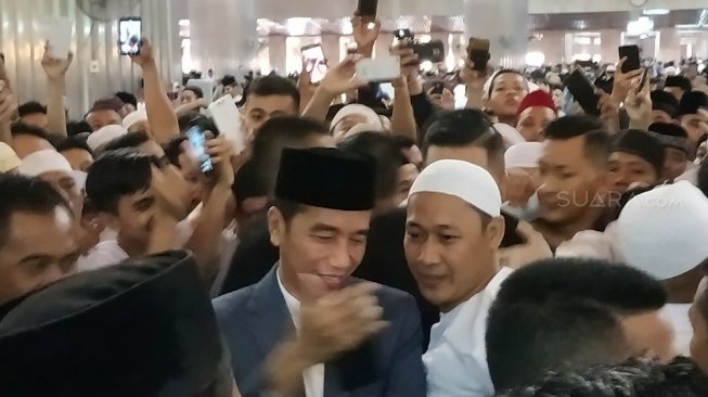 Paspamres agak kewalahan menangani antusiasme warga yang berswafoto dengan Presiden NKRI Joko Widodo [Suara.com/Fakhri Fuadi].