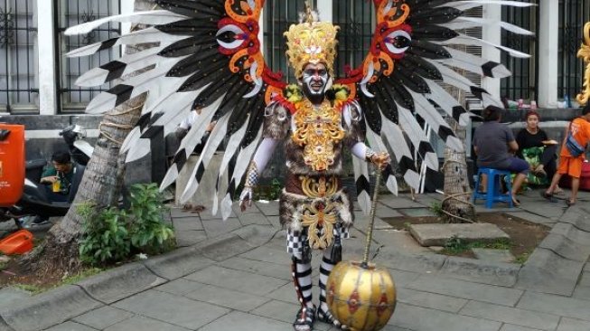 Pemakai kostum karnaval yang identik dengan aksesoris 'meriah' menjadi daya tarik tersendiri bagi pengunjung di Kota Tua, Jakarta Barat. (Suara.com/Fakhri Fuadi)