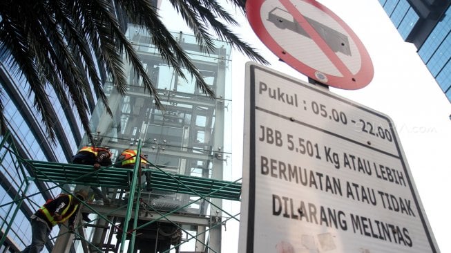 Pekerja menyelesaikan pembongkaran lift Jembatan Penyeberangan Orang (JPO) Tosari di kawasan Bundaran HI, Jakarta, Rabu (19/6). [Suara.com/Arief Hermawan P]