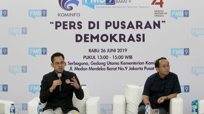 Ketua KPI Yuliandre Darwis (kiri) dan Ketua Komisi Hubungan Antar Lembaga Dewan Pers Agus Sudibyo (kanan) berdialog dalam kegiatan diskusi dan jumpa pers Kominfo Forum Merdeka Barat (FMB 9) di Kantor Kementerian Komunikasi dan Informasi (Kominfo), Jakarta, Rabu (26/7). [Suara.com/Arief Hermawan P]