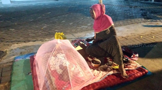 Imigran pencari suaka asal Sudan, Safuad bersama bayinya tinggal di troatoar Jalan Kebon Sirih, Jakarta Pusat, Selasa (9/7/2019). [Suara.com/Fakhri Fuadi Muflih]