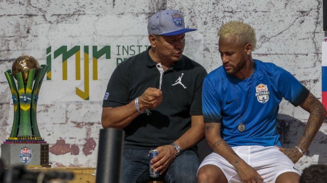Neymar berasama ayahnya, Neymar da Silva Sr, bercengkrama saat menghadiri laga amal. (Miguel SCHINCARIOL / AFP)