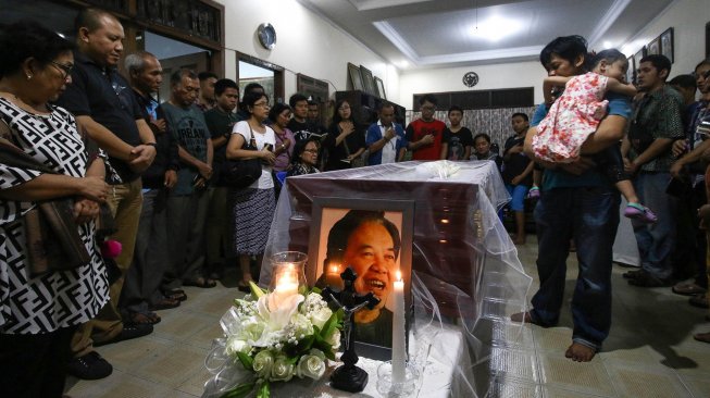 Sejumlah kerabat dan anggota keluarga berdoa di dekat jenazah Sastrawan Arswendo Atmowiloto di Rumah Duka Petukangan Selatan, Jakarta, Jumat (19/7). [ANTARA FOTO/Rivan Awal Lingga]