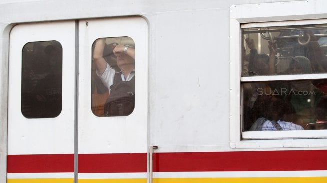 Rangkaian kereta commuter line saat melintas di dekat Stasiun Manggarai, Jakarta, Senin (5/8). [Suara.com/Oke Atmaja]
