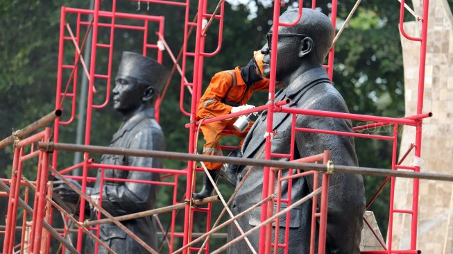 Petugas Dinas Pariwisata dan Kebudayaan Provinsi DKI Jakarta melakukan konservasi patung proklamator di Tugu Proklamasi, Jakarta, Kamis (8/8). [Suara.com/Arya Manggala]