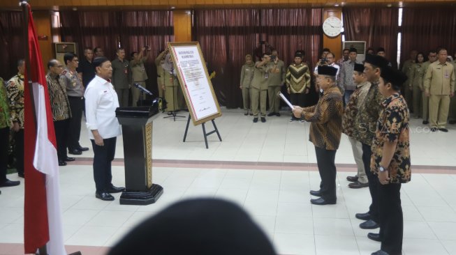 Keluarga besar Harokah Islam Indonesia, eks DI/TII dan eks NII membacakan ikrar setia kepada Pancasila, UUD 1945, dan Bhinneka Tunggal Ika di Kantor Kemenko Polhukam, Jakarta, Selasa (13/8). [Suara.com/Arya Manggala]