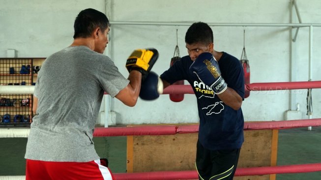 Petinju Indonesia Ongen Saknosiwi (kanan) menjalani latihan dengan pelatih Zulfren Saragih di Dirgantara Boxing Camp, Mabes TNI-AU, Cilangkap, Jakarta Timur, Rabu (14//8/2019). [Suara.com/Arief Apriadi]