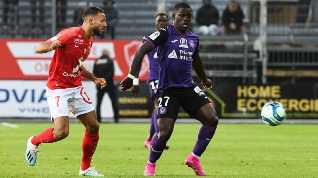 Gelandang Brest, Haris Belkebla (kiri) berebut bola dengan pemain gelandang Toulouse, Jean Victor Makengo pada Liga Prancis 2019/20 di Stadion Le Ble Francis, Sabtu (10/8/2019). (Fred TANNEAU / AFP)