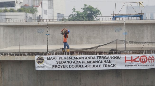 Pekerja merampungkan proyek double-double track (DDT) atau rel ganda Manggarai-Bekasi, Jakarta, Kamis (5/9). Proyek yang menghabiskan dana mencapai Rp 7 triliun tersebut ditargetkan selesai pada tahun 2021. [Suara.com/Angga Budhiyanto]