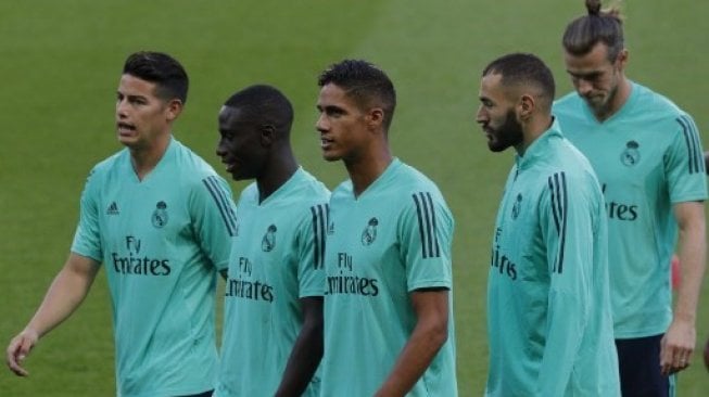 James Rodriguez (kiri) dan para pemain Real Madrid sebelum menjalani latihan guna menghadapi Paris Saint-Germain di fase grup A Liga Champions. GEOFFROY VAN DER HASSELT / AFP.