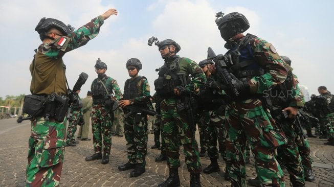 Anggota Polri Dan TNI mengikuti Apel Gelar Pasukan Pengamanan Pelantikan Presiden dan Wakil Presiden periode 2019-2024 di Lapangan Silang Monas, Jakarta, Kamis (17/10). [Suara.com/Arya Manggala]