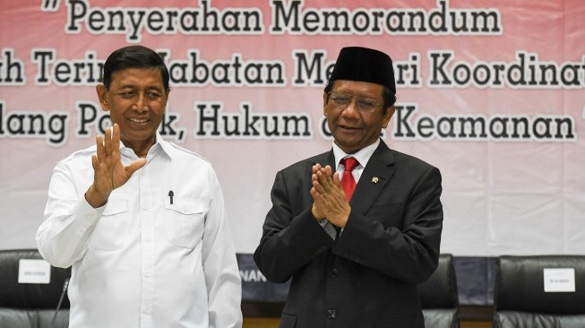 Menko Polhukam Mahfud MD (kanan) bersama pejabat lama Wiranto saat serah terima jabatan di kantor Kemenko Polhukam, Jakarta, Rabu (23/10). [ANTARA FOTO/Hafidz Mubarak]