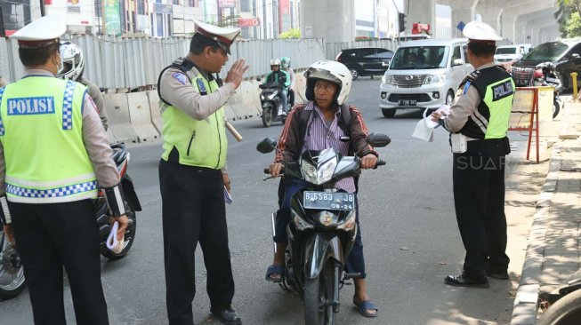 Petugas kepolisian memeriksa kelengkapan surat kendaraan bermotor saat Operasi Zebra Jaya 2019 di Jalan Boulevard, Jakarta, Kamis (24/10). [Suara.com/Arya Manggala]