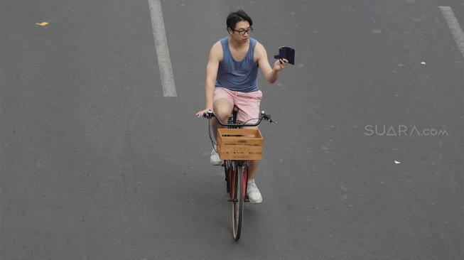 Warga beraktivitas di area 'car free day' (CFD) di kawasan Bundaran Hotel Indonesia, Jakarta, Minggu (27/10). [Suara.com/Angga Budhiyanto]