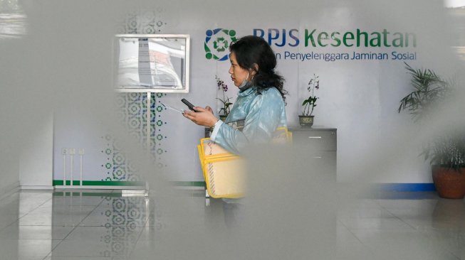 Pegawai melayani warga di kantor Badan Penyelenggara Jaminan Sosial (BPJS) Kesehatan Jakarta Timur, di Jakarta, Rabu (30/10). [ANTARA FOTO/M Risyal Hidayat]