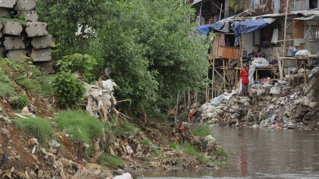 Warga beraktivitas di bantaran Sungai Ciliwung, Kampung Tanah Rendah, Jakarta, Kamis (14/11). [Suara.com/Angga Budhiyanto]