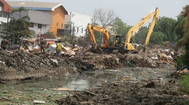 Petugas dengan alat berat membongkar bangunan liar di kawasan Sunter, Jakarta, Senin (18/11). [Suara.com/Arya Manggala]