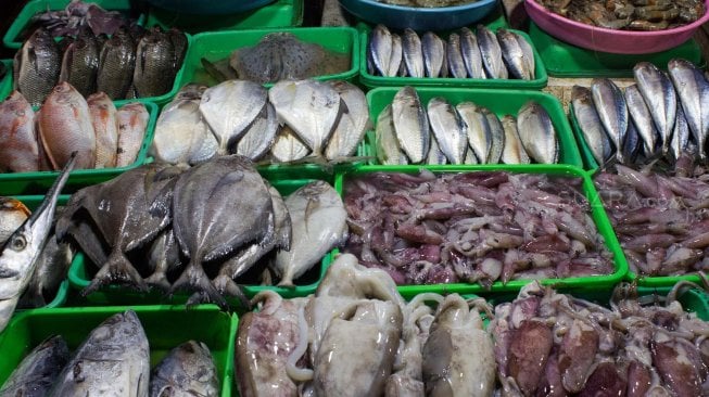 Pedagang ikan menjajakan daganganya untuk berjualan di Jalan Kramat Jati, Jakarta Timur, Senin (2/12). [Suara.com/Alfian Winanto]