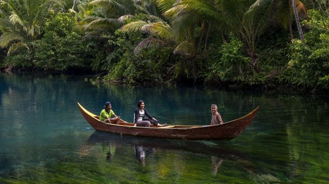 Pengunjung berkeliling dengan perahu di obyek wisata Danau Paisupok di Desa Lukpanenteng, Kabupaten Banggai Kepulauan, Sulawesi Tengah, Selasa (3/12). [ANTARA FOTO/Basri Marzuki]