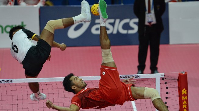 Pesepak takraw Indonesia Saiful Rijal (kanan) melakukan smes yang diblok pesepak takraw Myanmar Aung Naing Oo dalam pertandingan babak Final Sepak Takraw Ganda Beregu Putra SEA Games ke-30 di Subic Gymnasium, Filipina, Kamis (5/12). [ANTARA FOTO/Nyoman Budhiana]